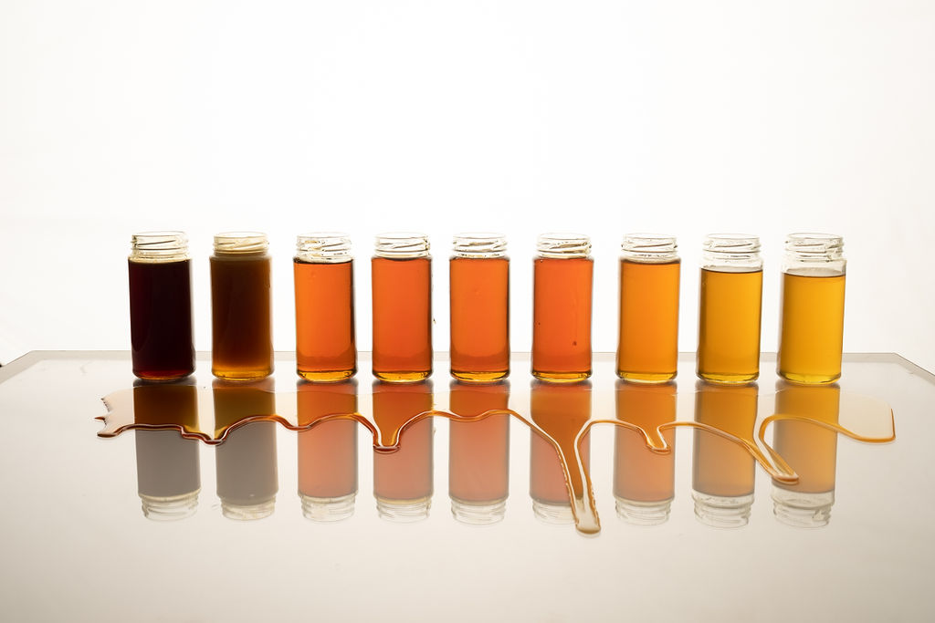 Shades of Honey shown in transparent bottles